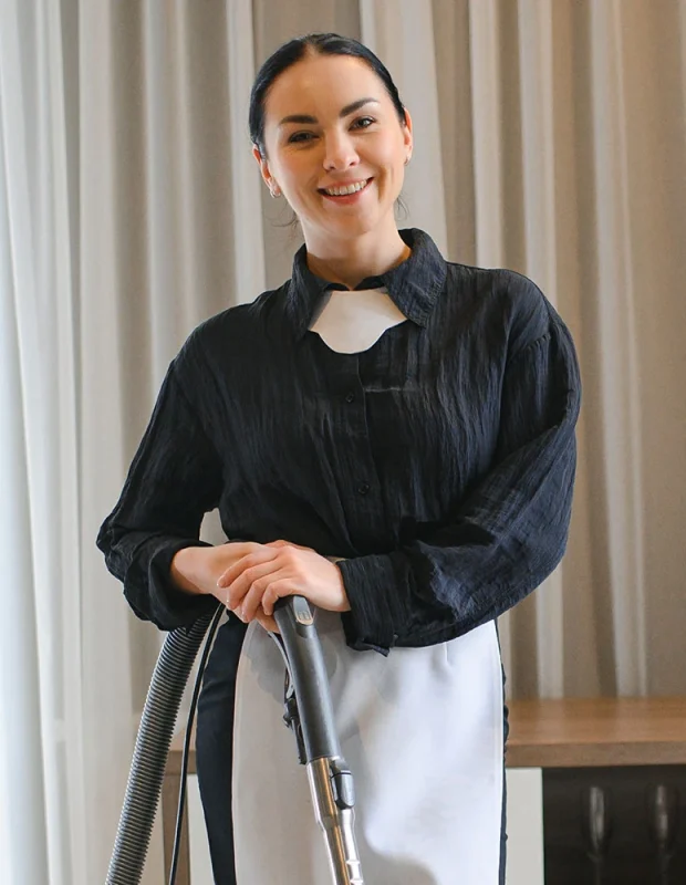 female-housekeeping-worker-with-vac-HMVWFNQ